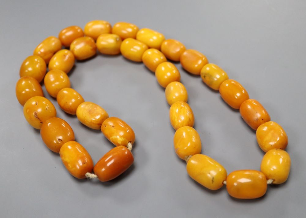 A single strand oval amber bead necklace, 74cm, gross weight 128 grams,